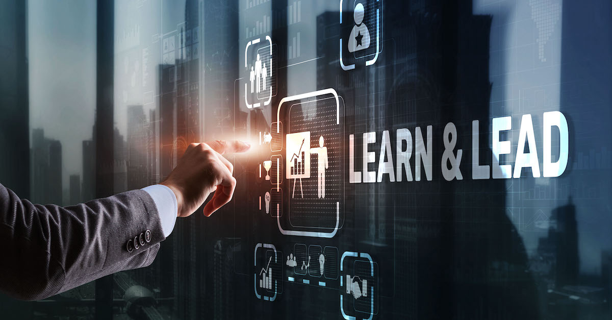 Learn and Lead. Businessman presses hand on the virtual screen inscription